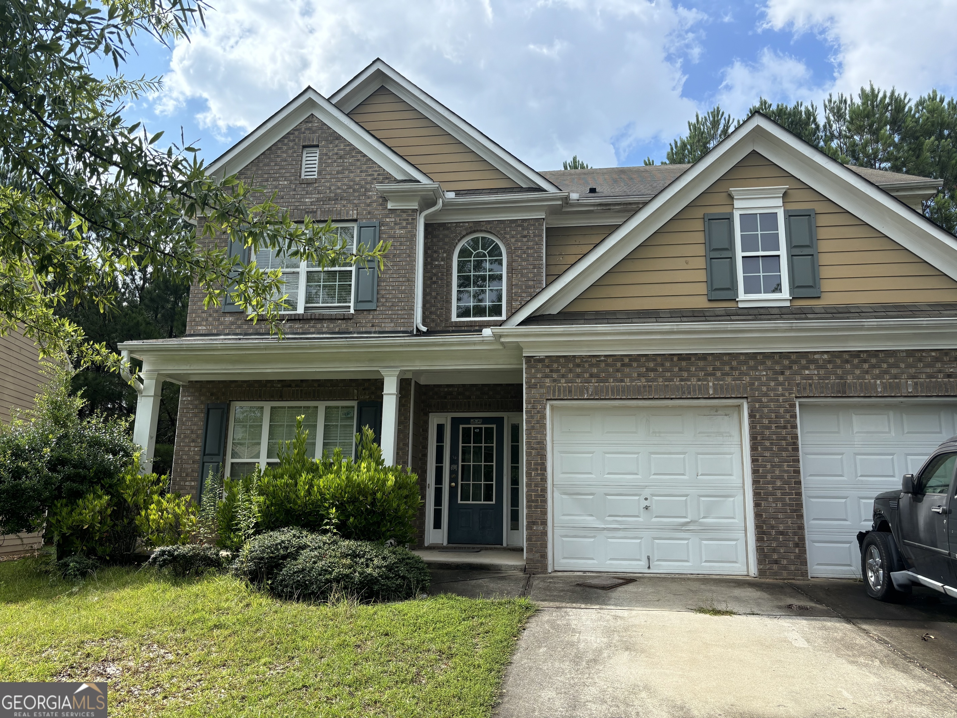 a front view of a house with a yard