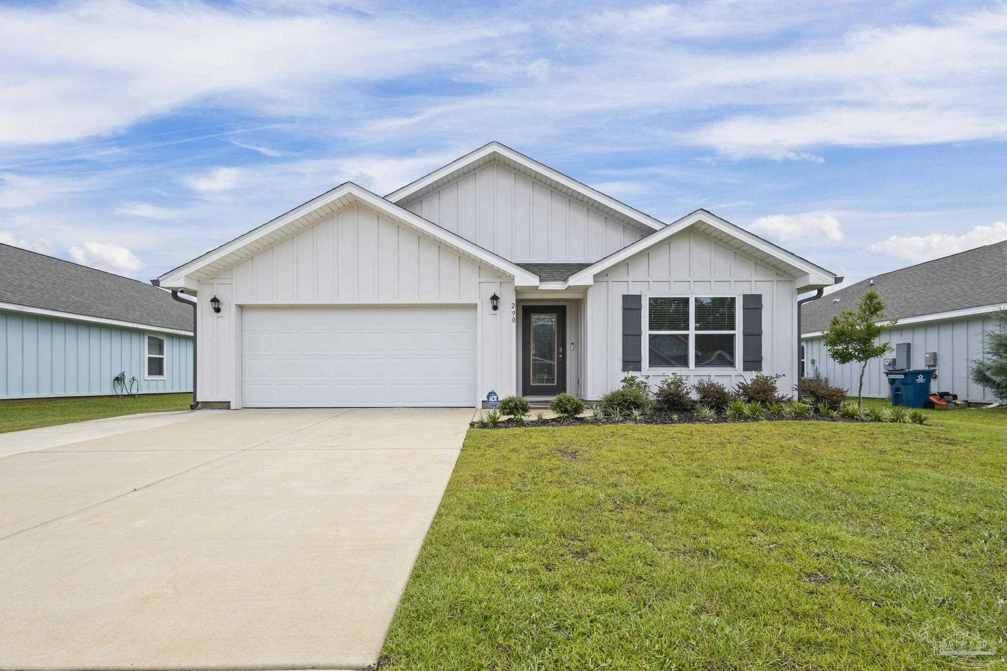 a view of a house with a yard and garage