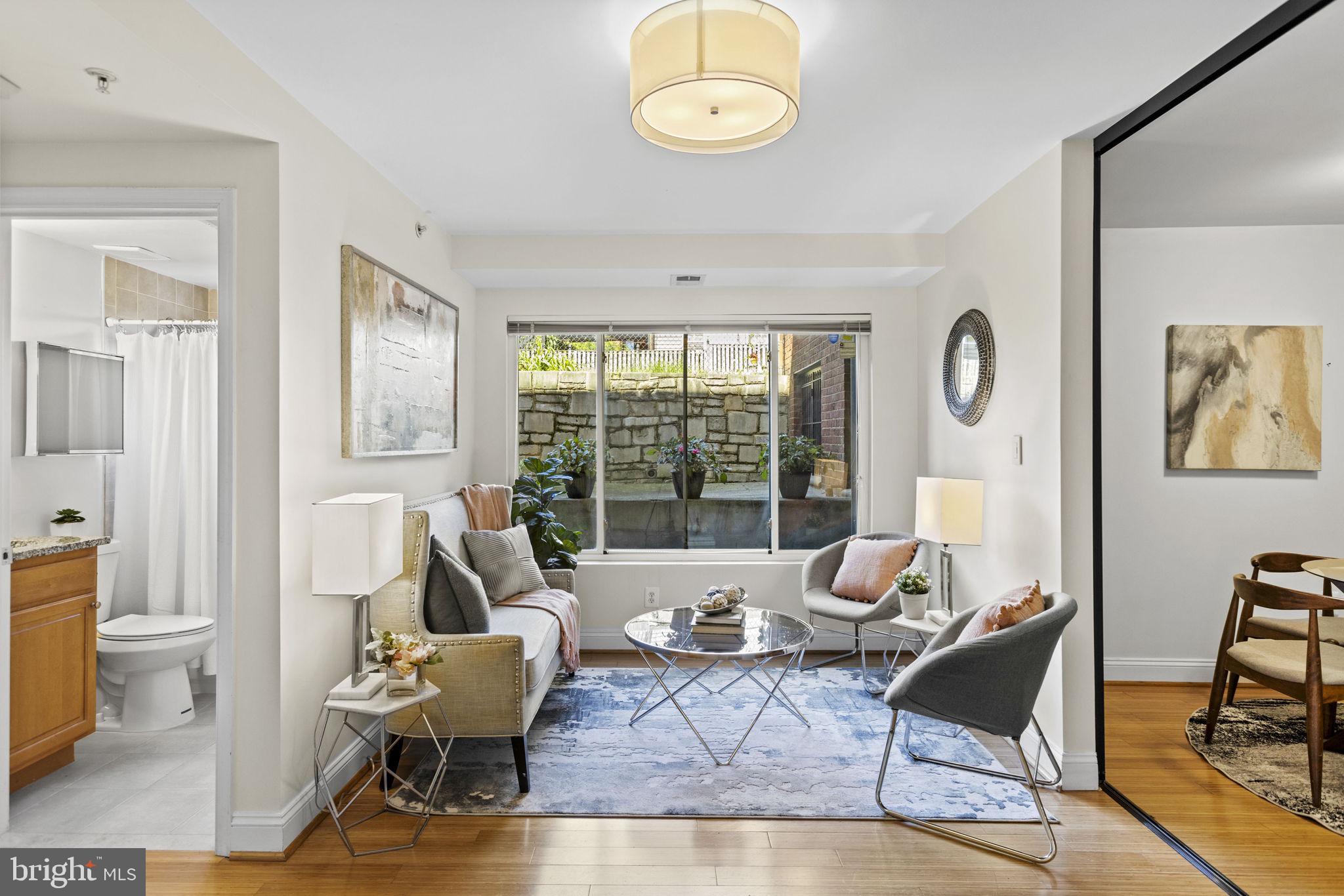 a living room with furniture and a large window