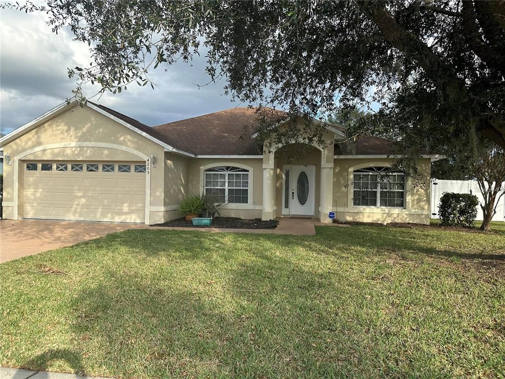 a view of a house with a backyard