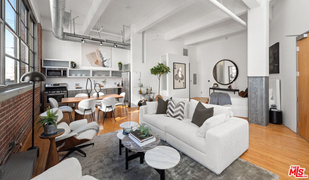 a living room with furniture a rug and a chandelier