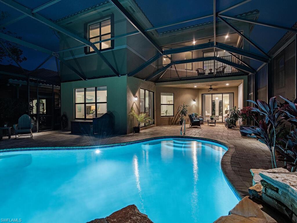 a view of a swimming pool with outdoor seating