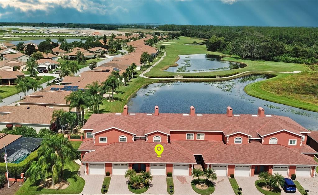 an aerial view of residential houses with outdoor space and a swimming pool