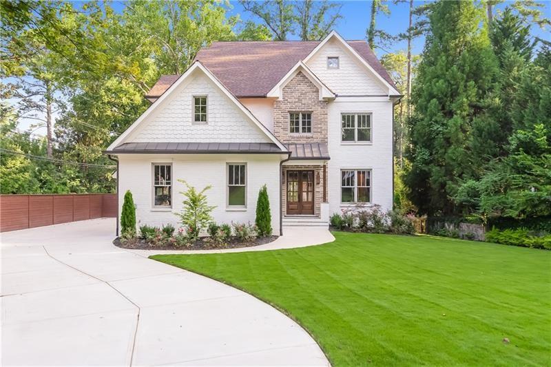 a front view of a house with a yard and porch