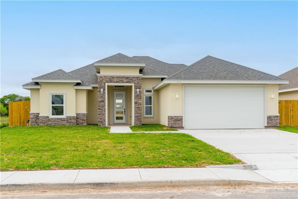 Prairie-style house with a front yard and a garage