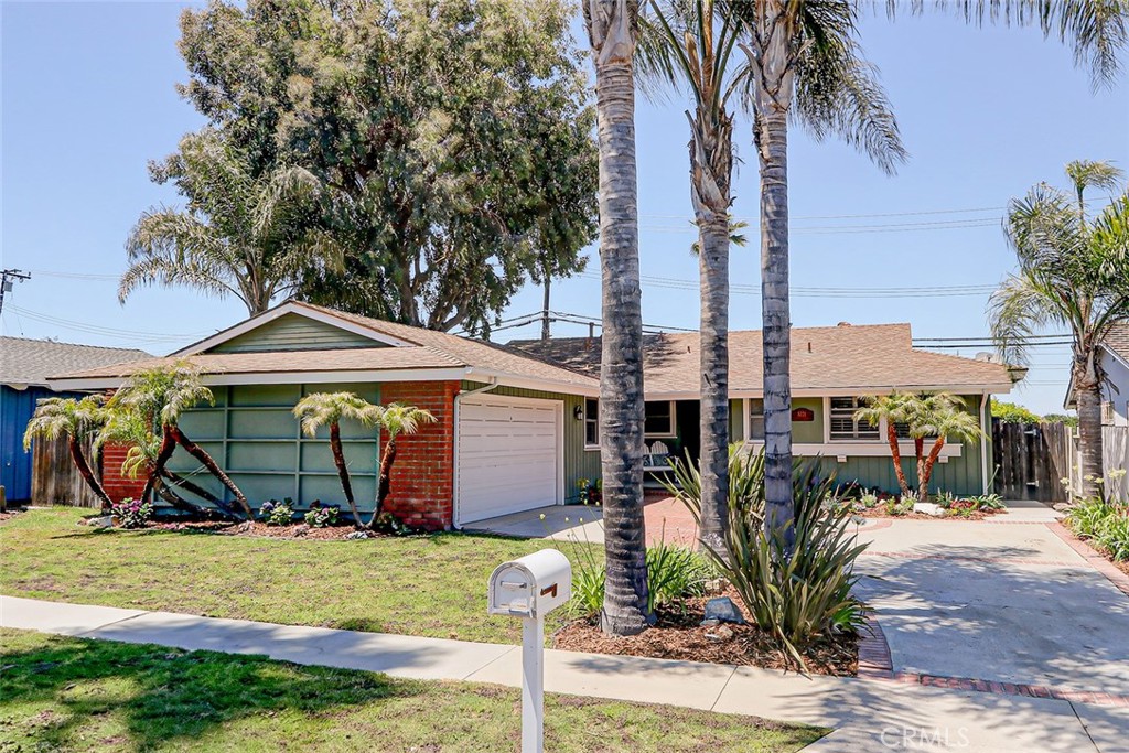 a view of a house with a yard and potted plants