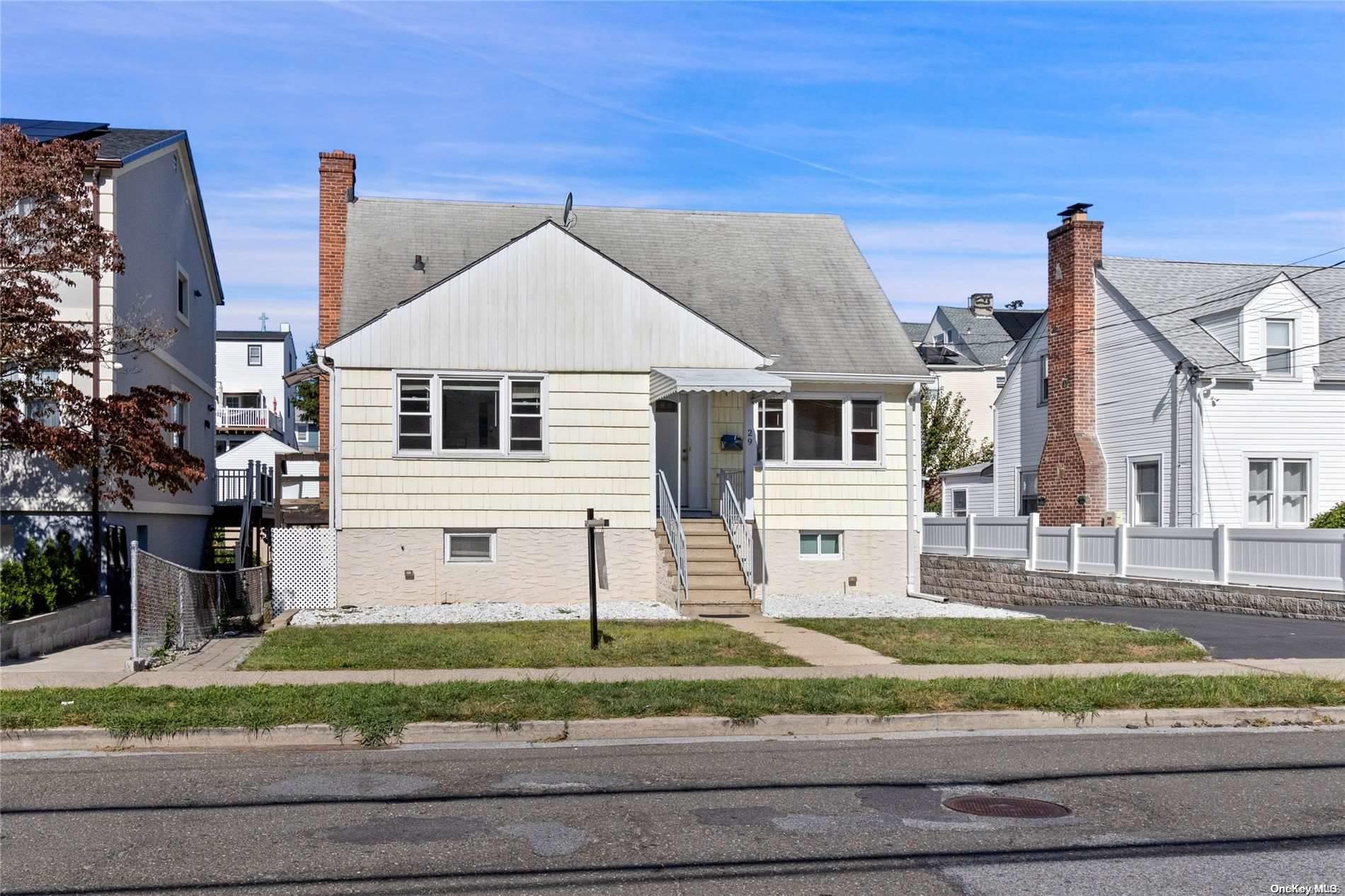 a view of a house with a small yard and plants