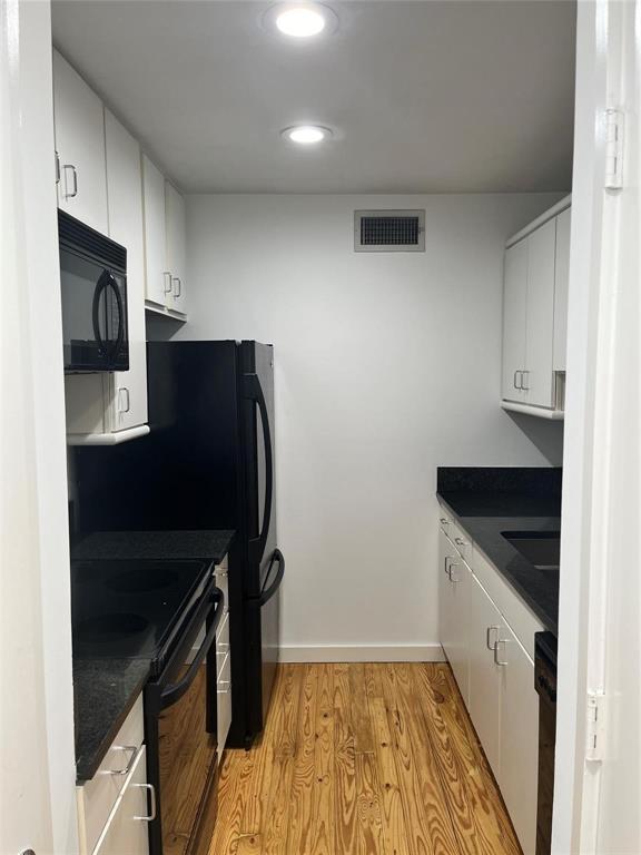 a kitchen with granite countertop a refrigerator stove and sink