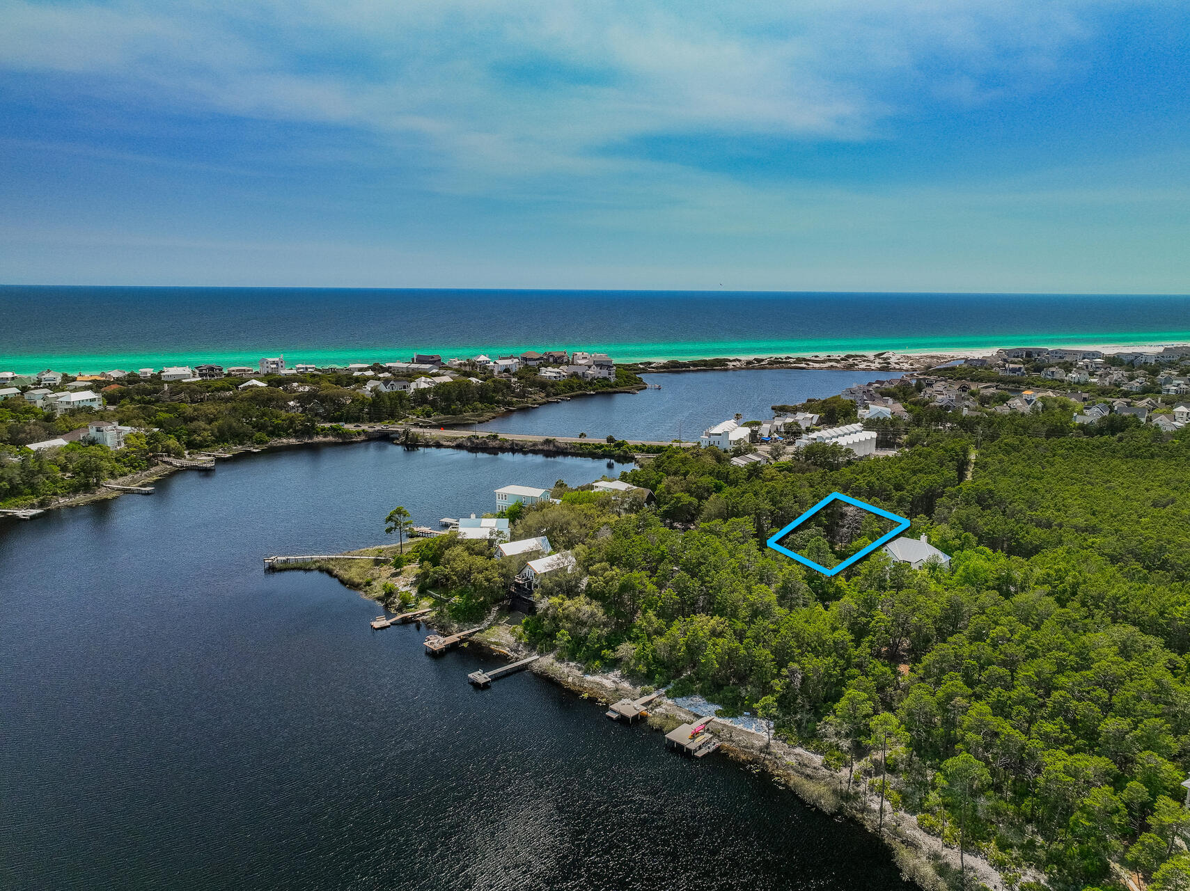 an aerial view of a houses with ocean view