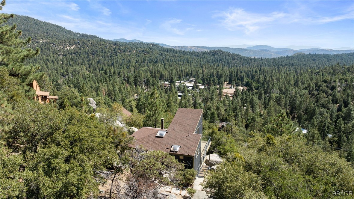 an aerial view of a house with mountain view