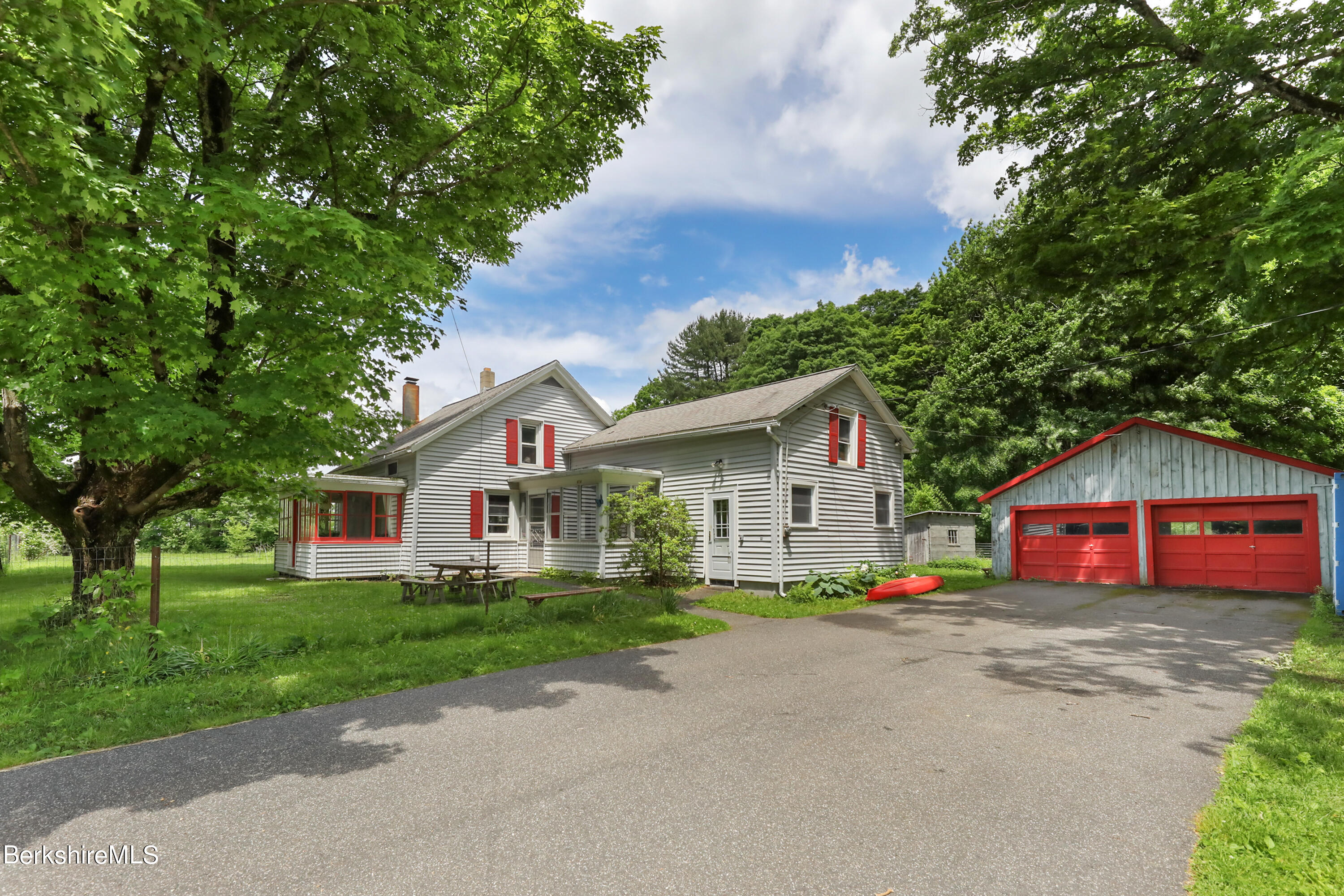 a front view of house with yard and green space