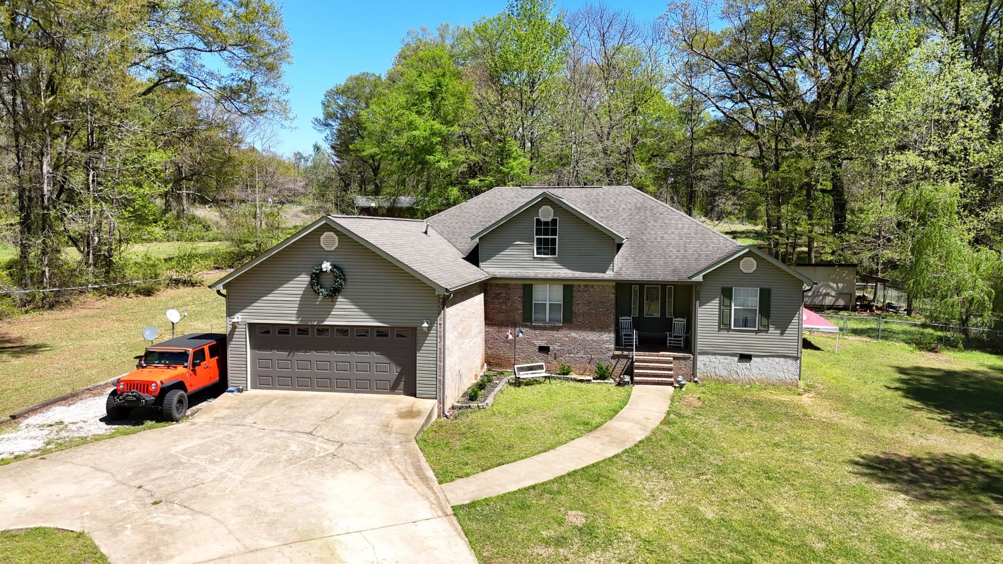 a front view of a house with a garden and fire pit