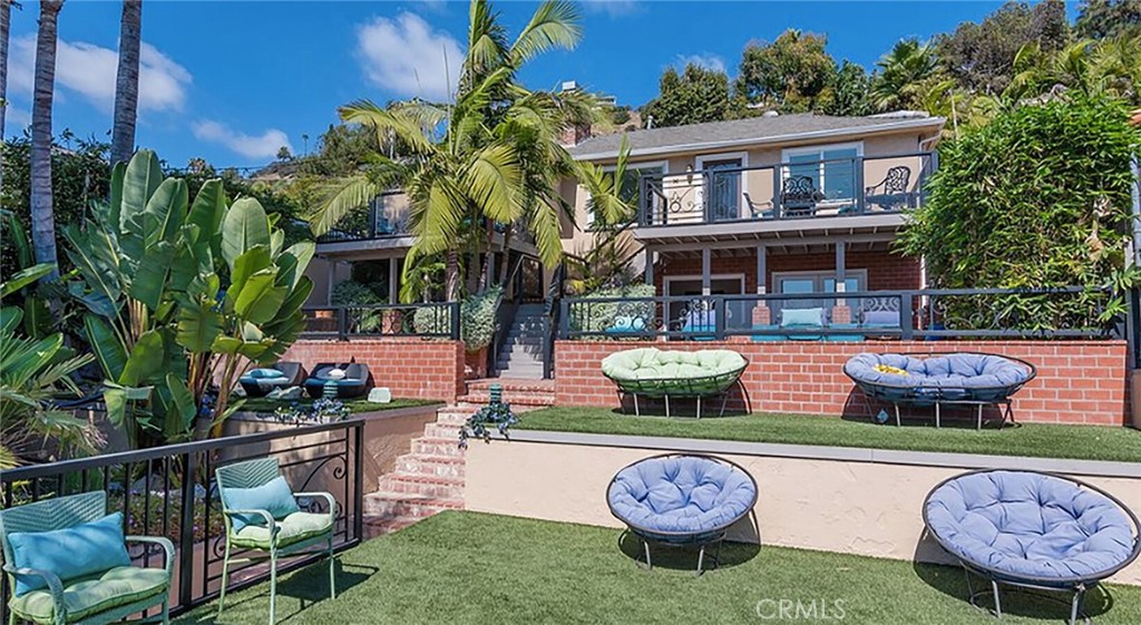 a front view of a house with swimming pool garden and patio