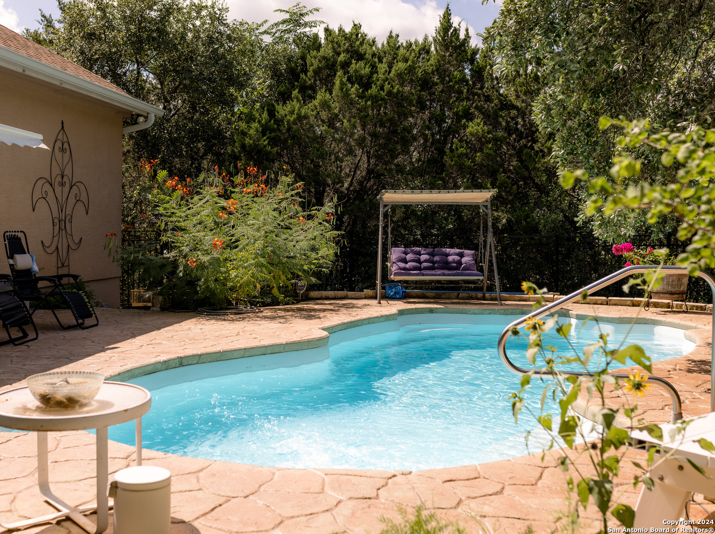 a view of swimming pool with a patio and a yard