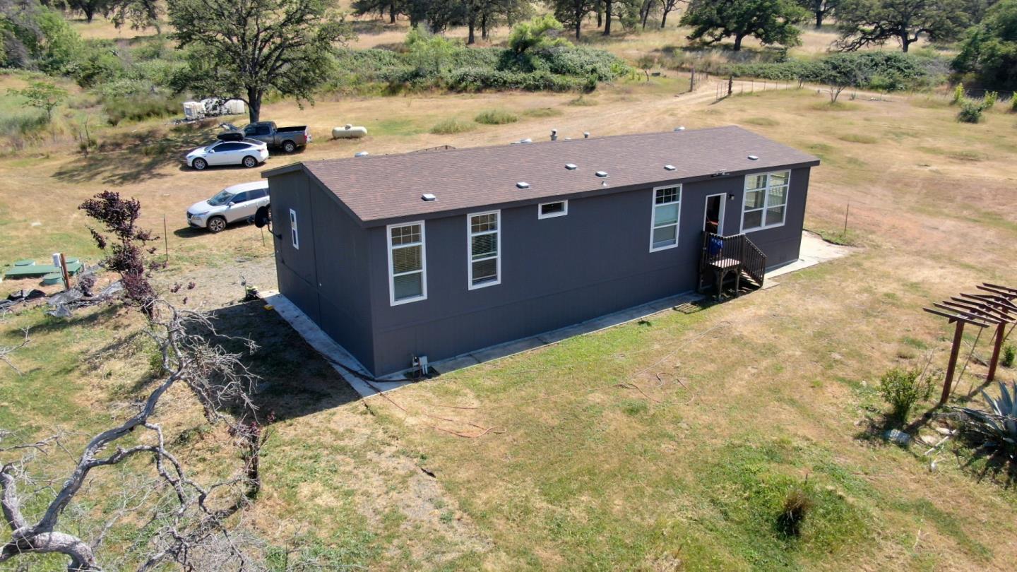 an aerial view of residential houses with yard