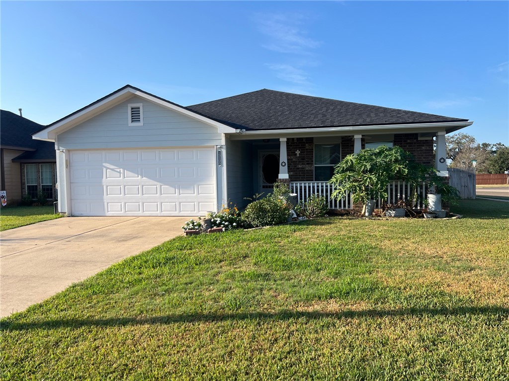 Single story home with a garage, a porch, and a fr