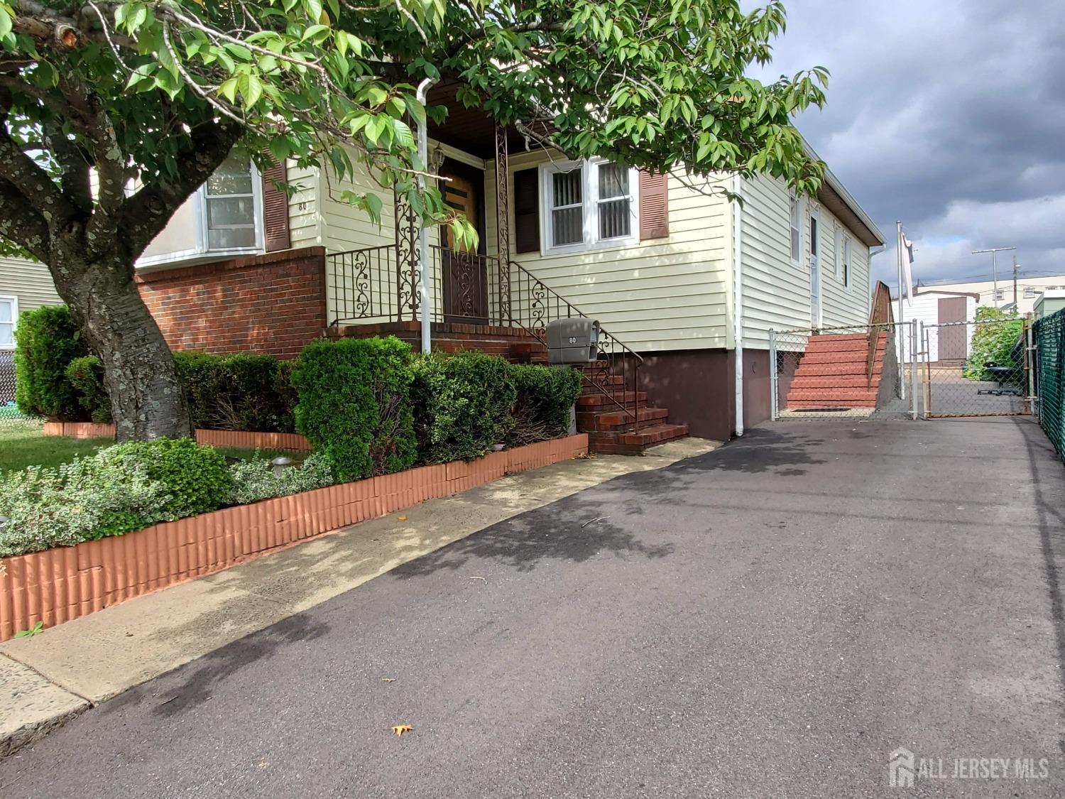 a view of a house with a yard and tree s