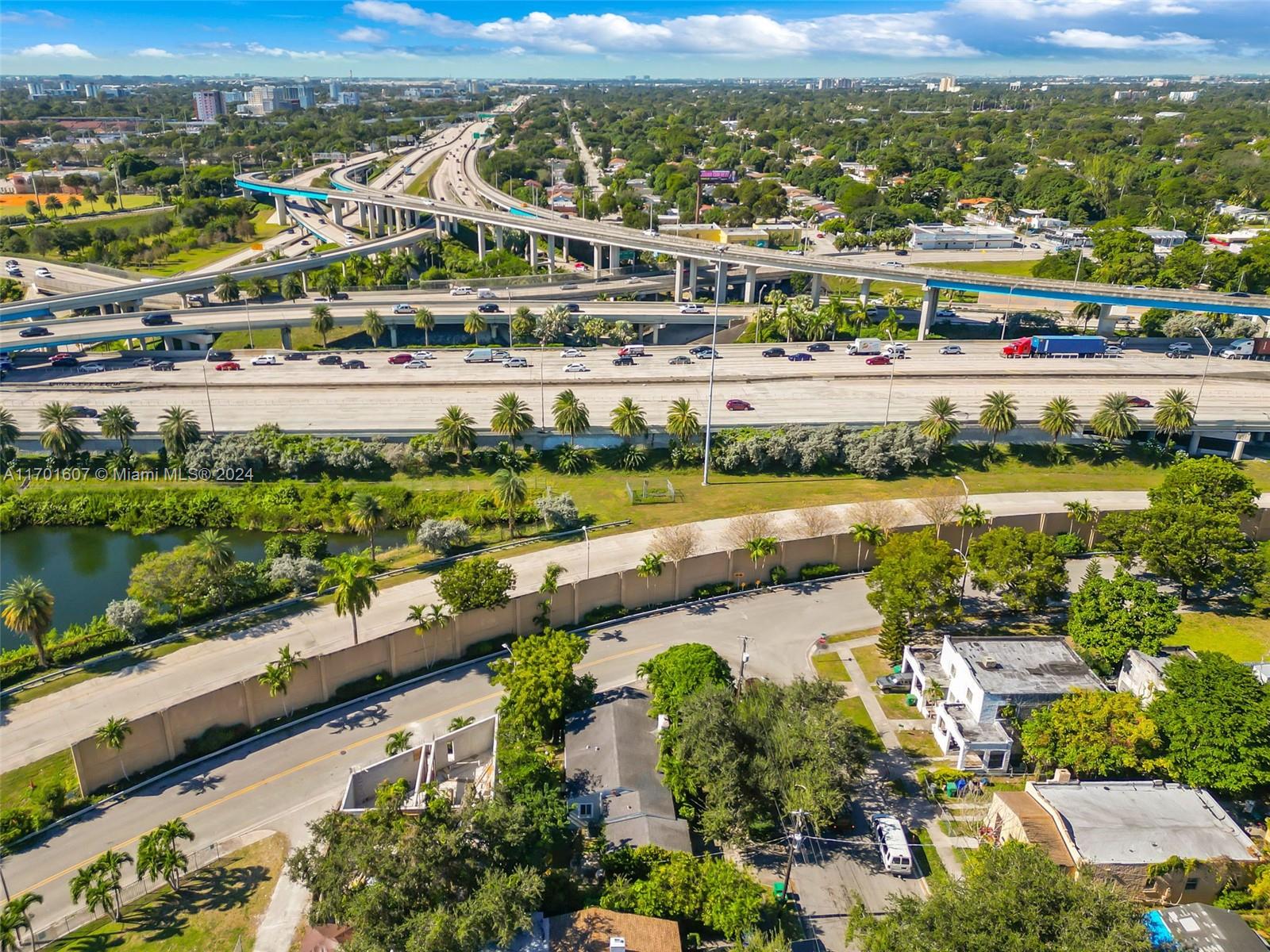 an aerial view of residential houses with outdoor space and river