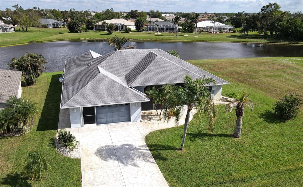 an aerial view of a house with garden space and lake view