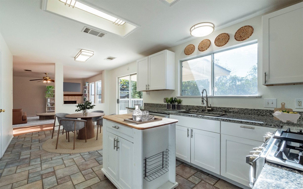 a kitchen with a sink stove and cabinets