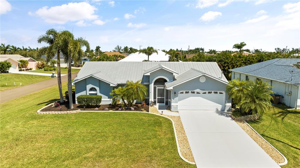 a view of a house with a yard and ocean view