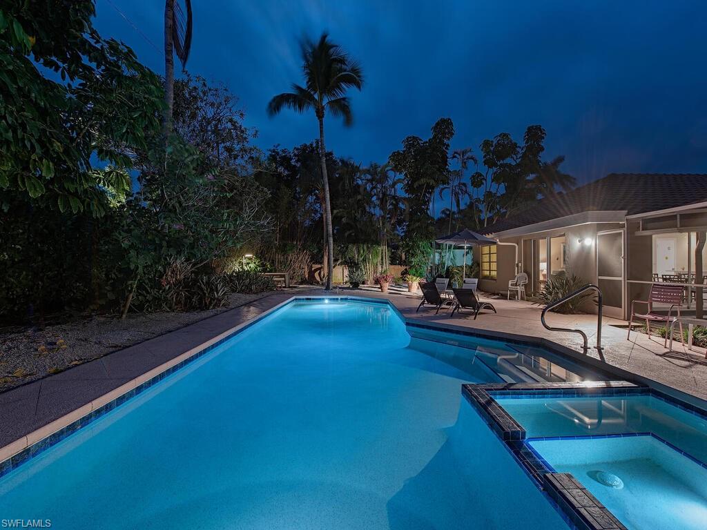 a swimming pool view with a outdoor seating space