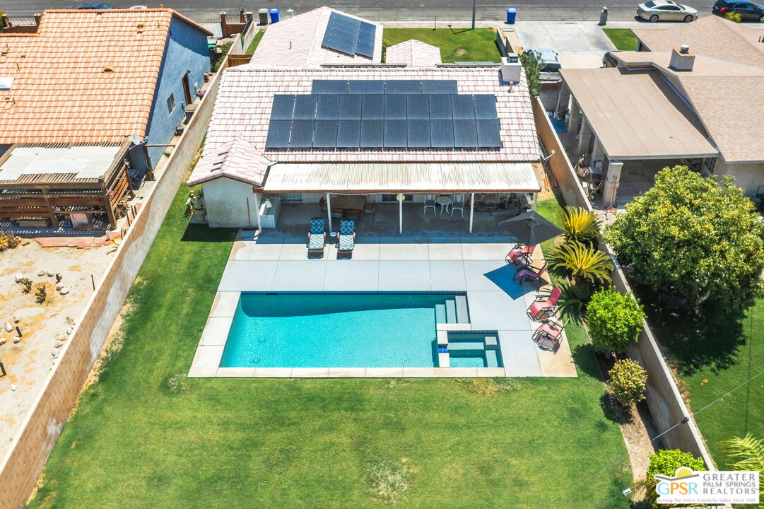 an aerial view of a house with a yard