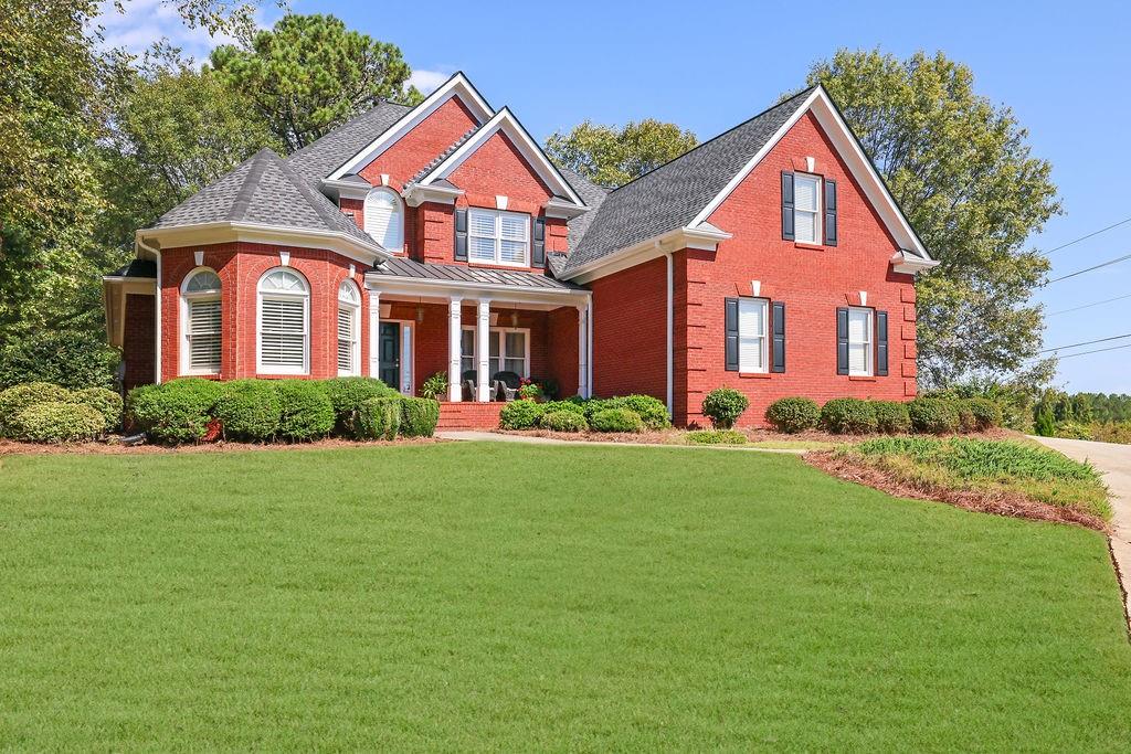 a front view of a house with a yard and garage