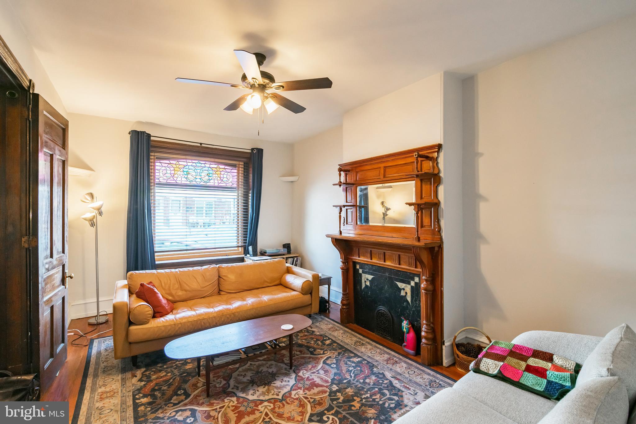 a living room with furniture a fireplace and a window