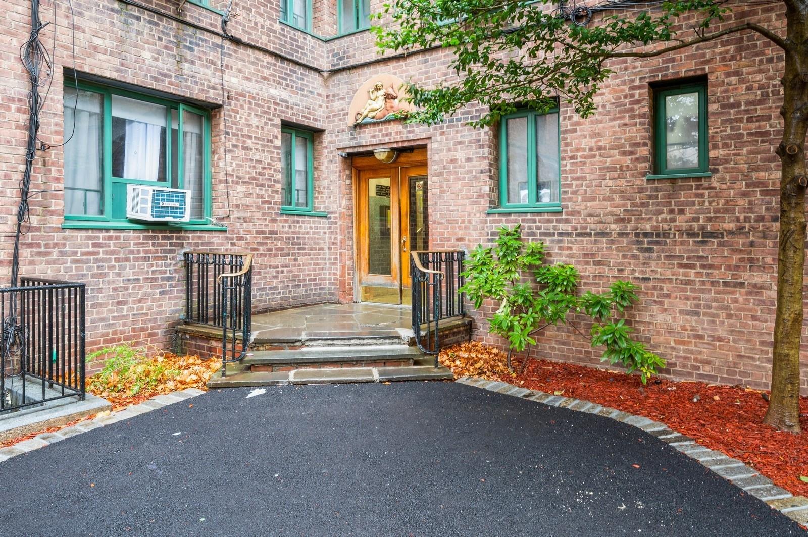 Property entrance featuring cooling unit