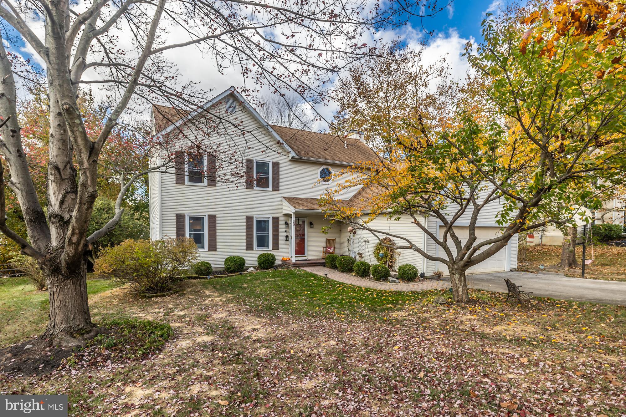 a house that has a tree in front of it