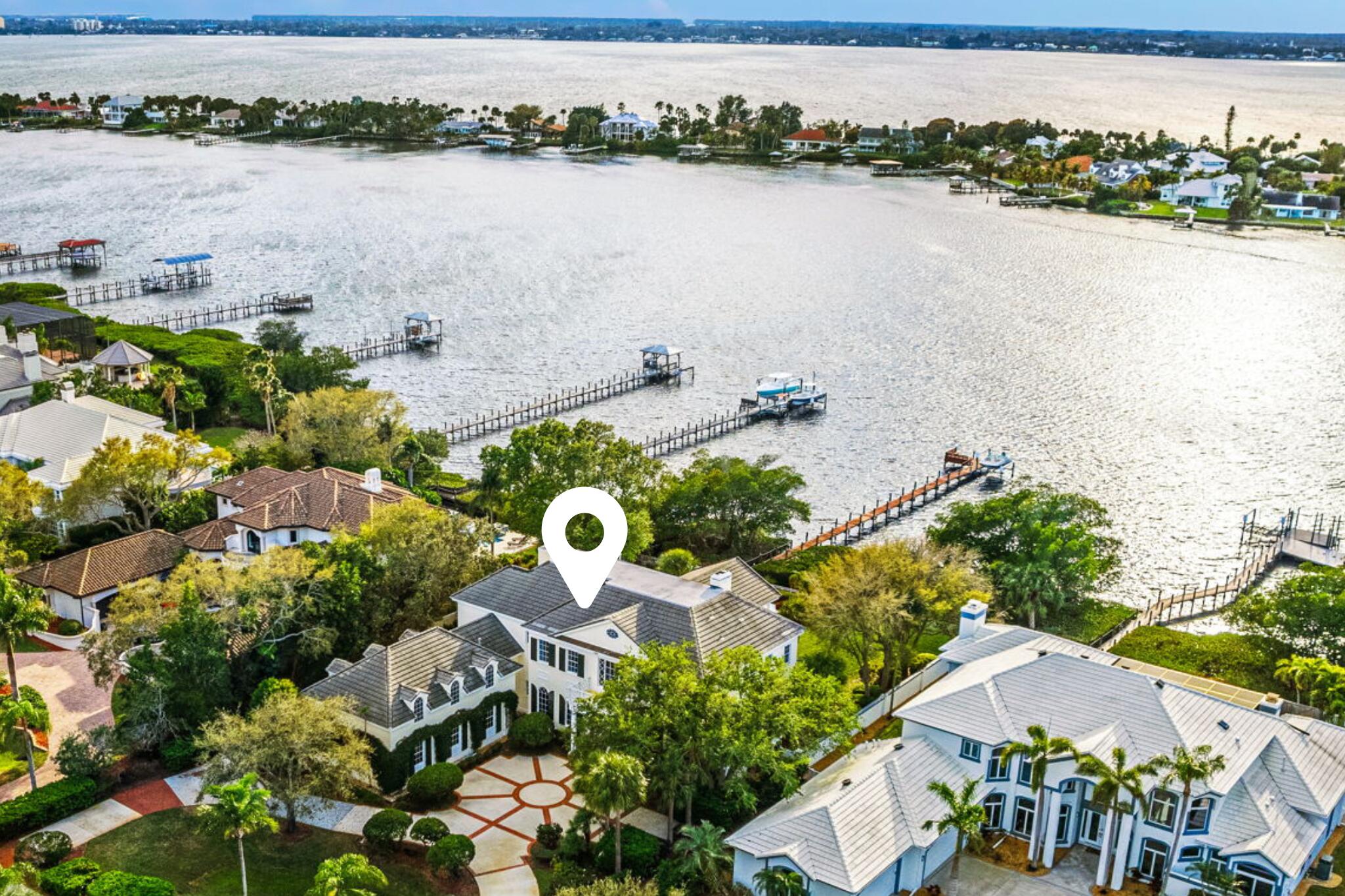 an aerial view of house with yard space and ocean view