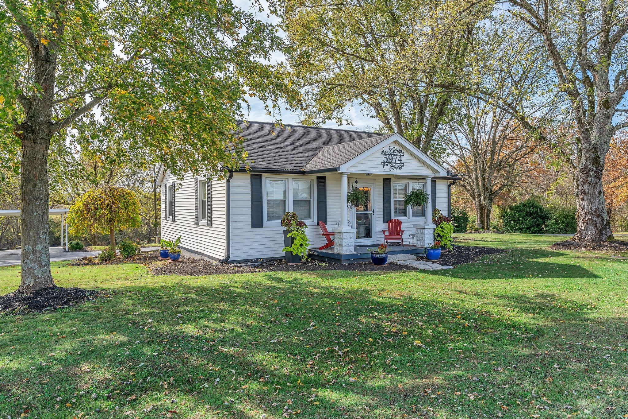 a view of a house with a yard porch and sitting area