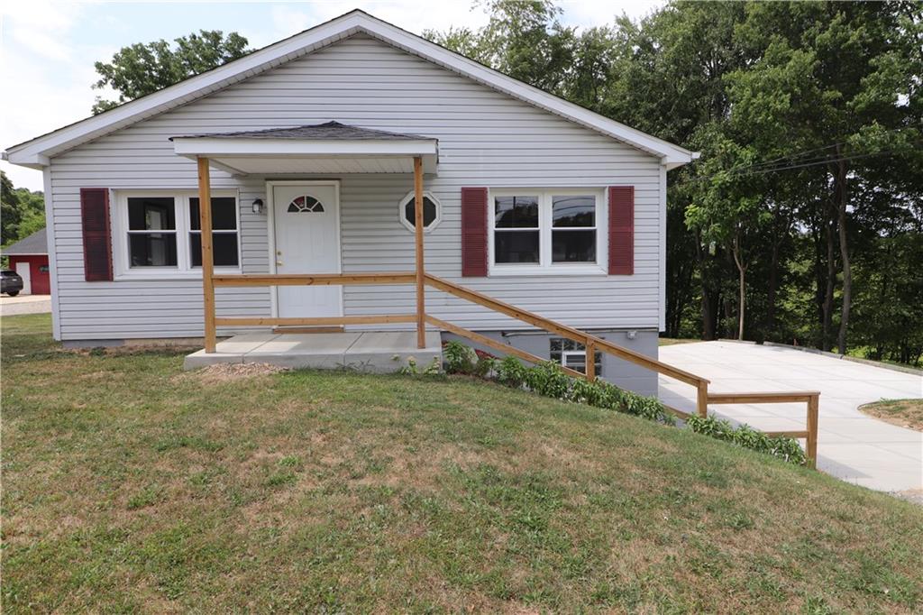 a view of house with backyard and garden