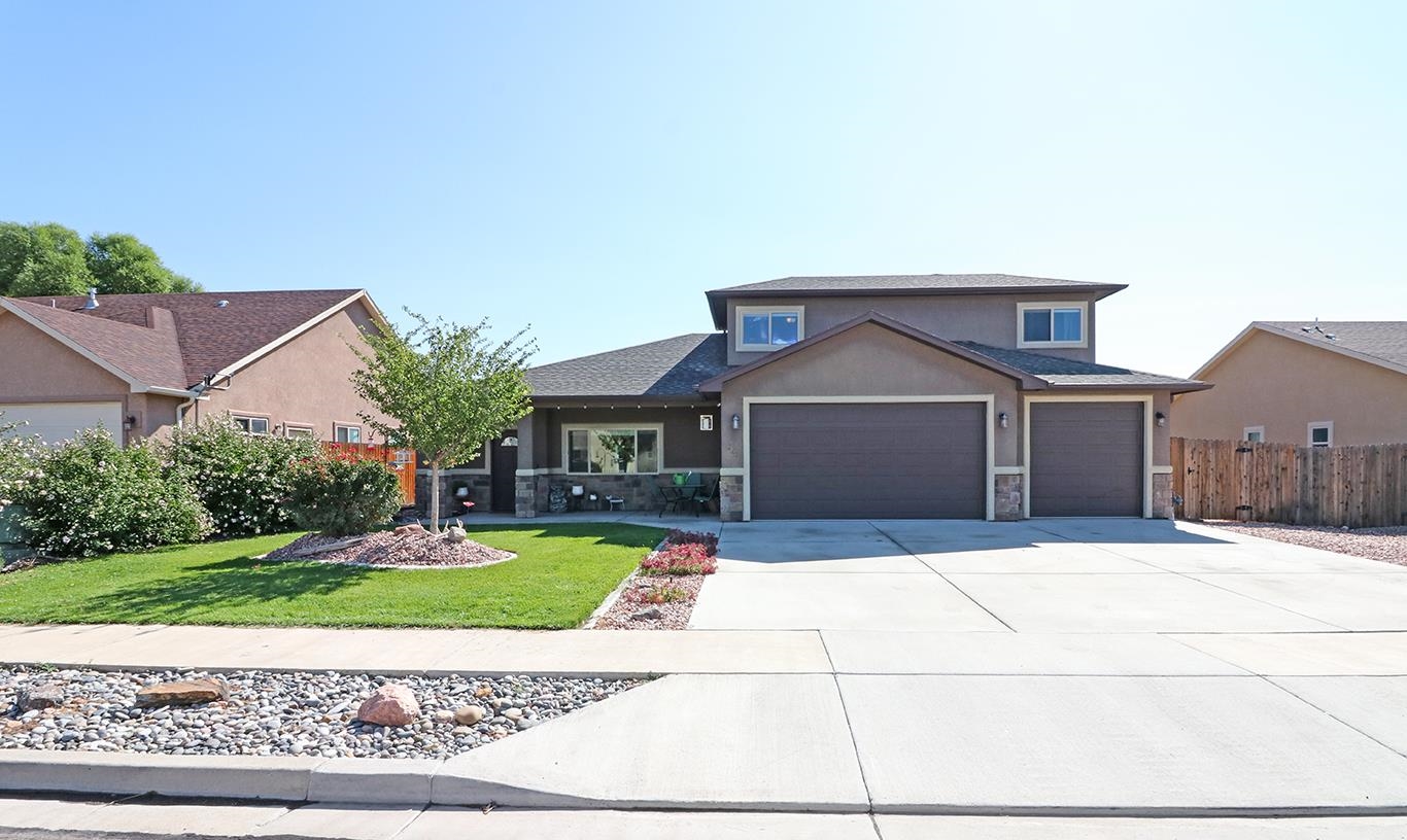 a front view of a house with a yard and garage