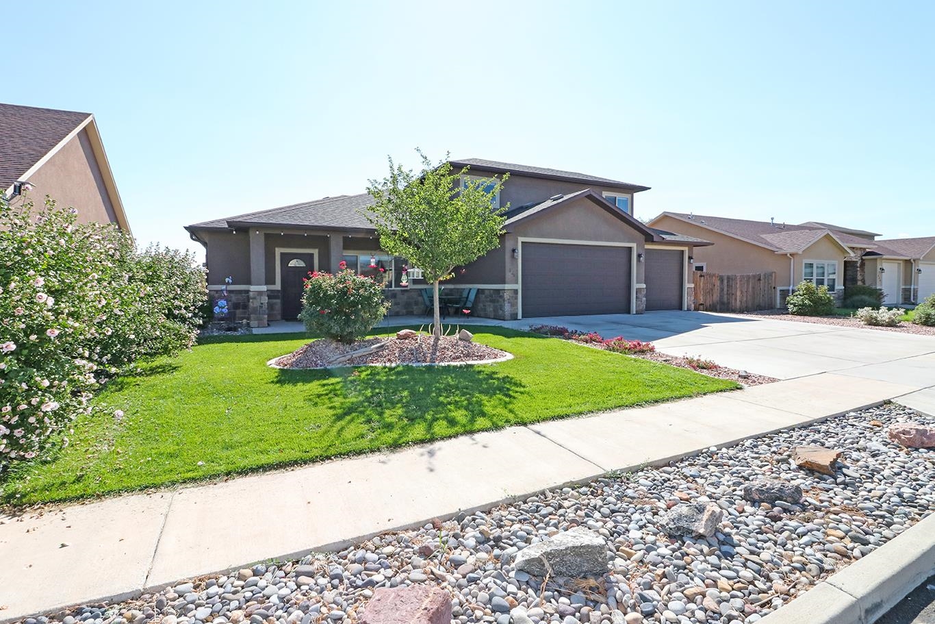 a front view of a house with a yard and garage