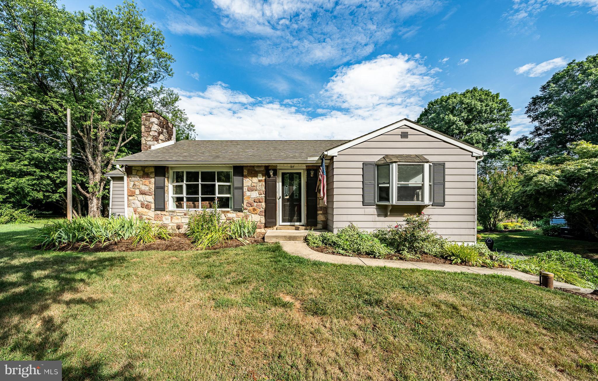 a front view of a house with garden