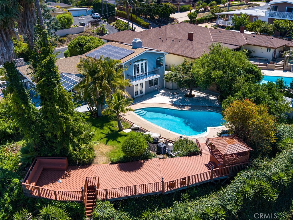 an aerial view of a house with garden space and street view