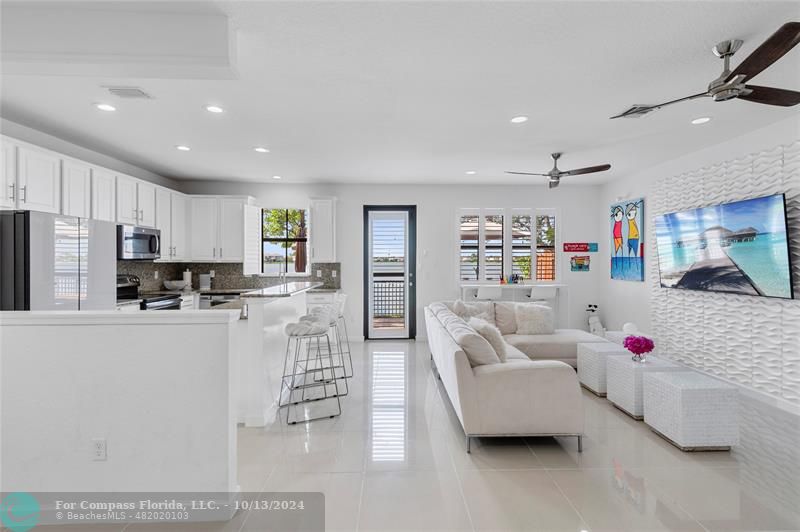 a living room with furniture and kitchen view