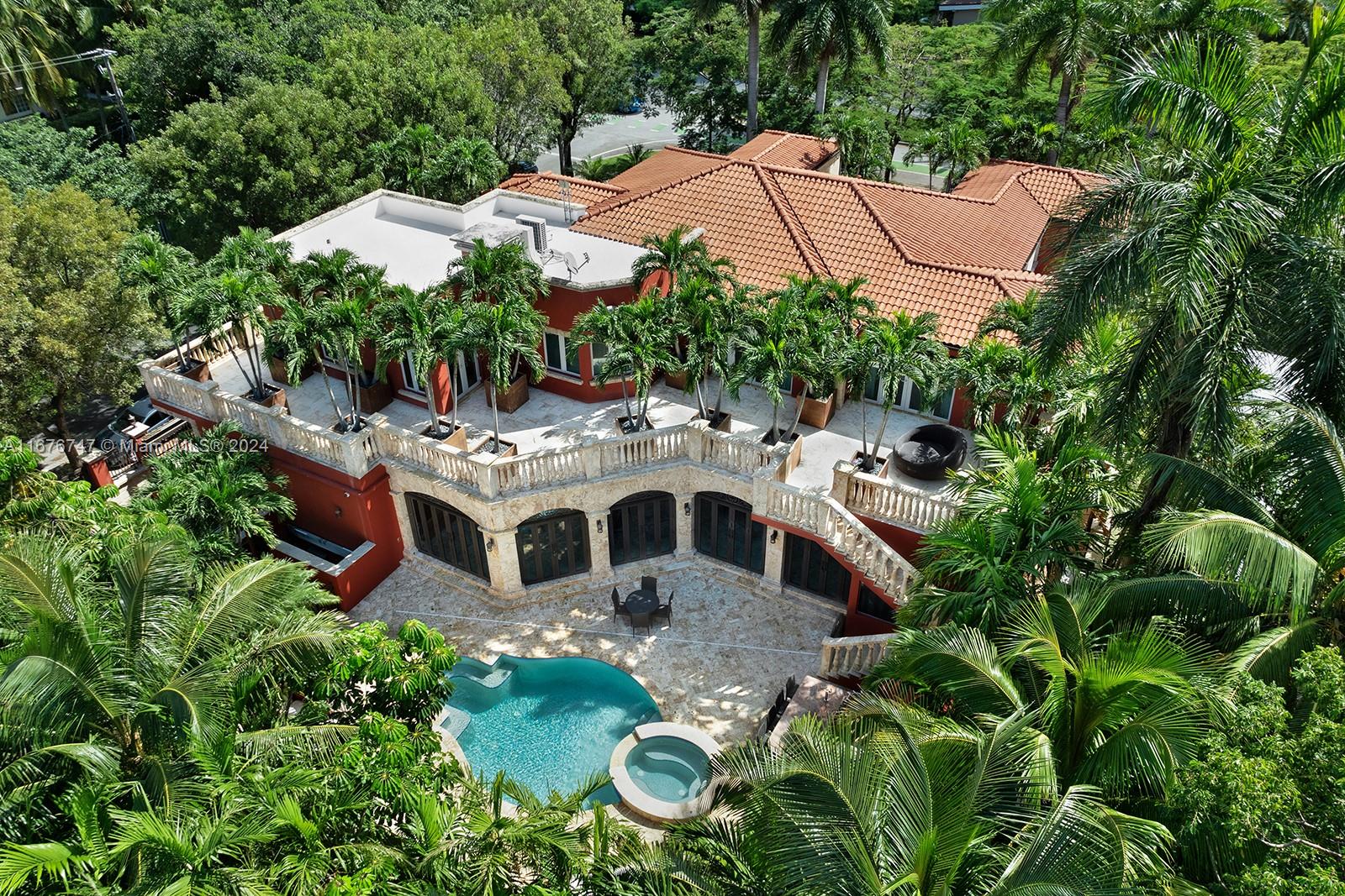 an aerial view of residential house with outdoor space and trees all around