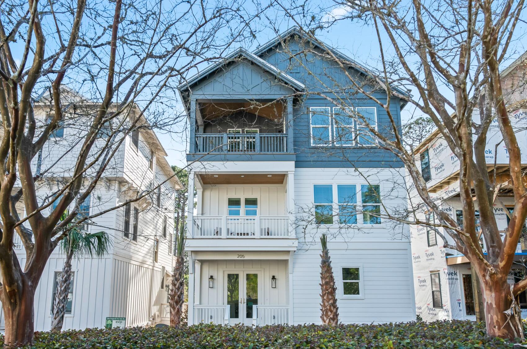 a front view of a house with a tree