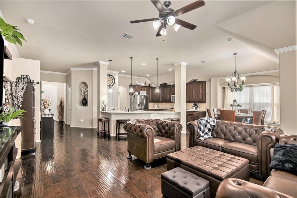 a living room with furniture and a chandelier