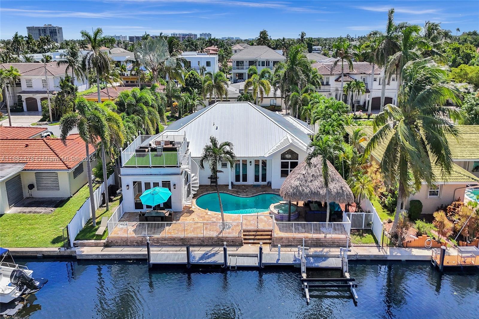 an aerial view of a house with swimming pool patio and outdoor seating