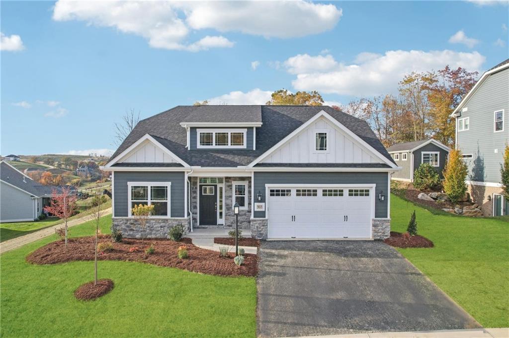 a front view of a house with a yard and garage