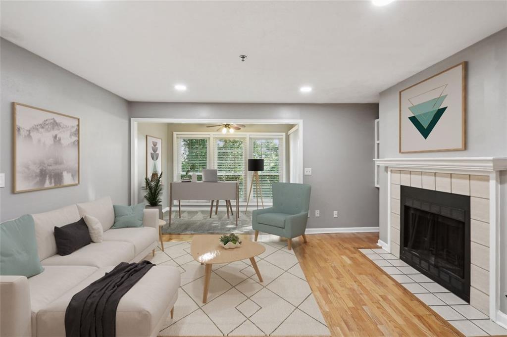 a living room with furniture large window and a fireplace