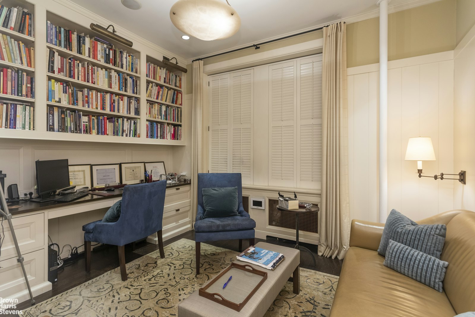 a living room with furniture and a book shelf