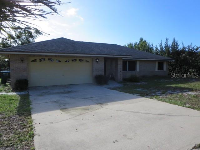 a view of house with yard and tree in front of it