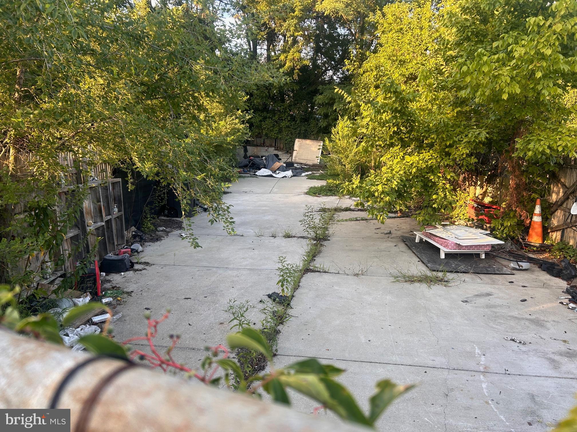 a view of a backyard with chairs and potted plants