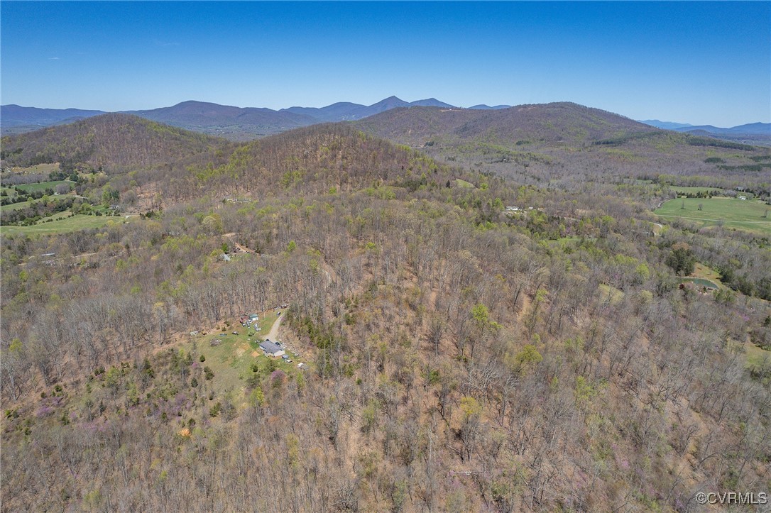 a view of a mountain range with trees in the background