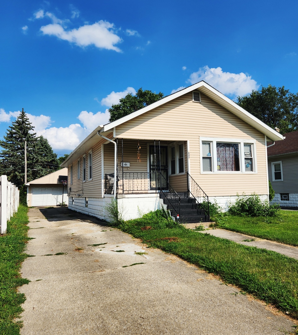 a front view of a house with a garden and yard